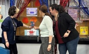 photo of Library employees placing votes in ballot box